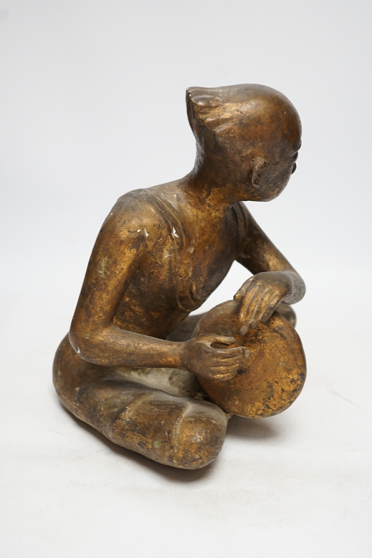 A South East Asian bronze and composition figure, 27cm high. Condition - fair